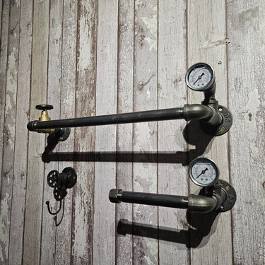 Steampunk industrial pipe wall shelf with pressure gauges and hooks on rustic wood panel