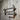 Industrial steampunk wall-mounted towel rail with pipe fittings and pressure gauges on rustic wood panel wall