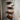 Steampunk industrial wall shelf with copper pipes, wood planks, and vintage gauges