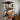 Industrial steampunk wall shelf with copper pipes, wood planks, and vintage gauges