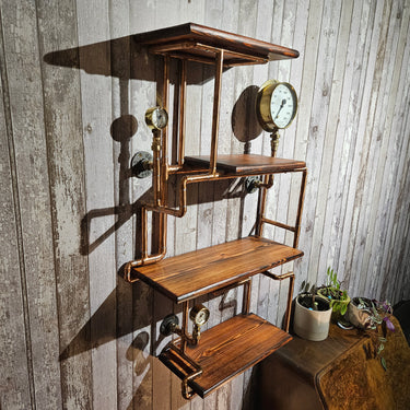Industrial steampunk wall shelf with copper pipes, wood planks, and vintage gauges