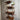 Industrial steampunk wall shelf with wood panels and metal pipe fittings on rustic wall