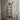 Industrial copper pipe wall shelf with brass fittings and red valve on rustic wood wall
