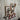 Industrial steampunk pipe wall rack with red hooks and gauge on rustic wood panel wall