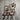 Steampunk industrial wall rack with copper pipes, red valve, and hooks on rustic wood