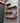 Industrial steampunk wall shelf with copper pipes, wood planks, gauge, and valve accents