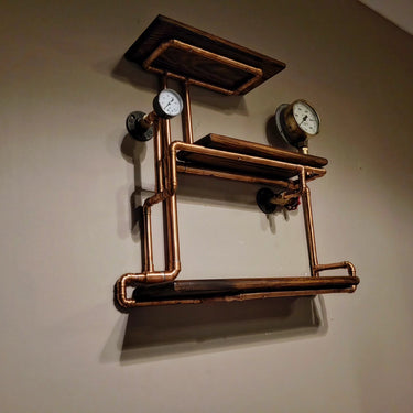 Industrial steampunk wall shelf with copper pipes, pressure gauges, and wooden planks