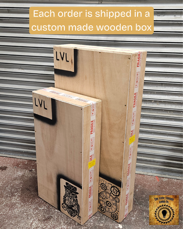 Two custom wooden shipping boxes with fragile tape, steampunk owl and gear designs.