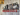 Industrial steampunk pipe coat rack with red hooks, pressure gauges, and wood wall backdrop