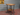Industrial side table with wooden shelves and metal pipe legs, steampunk furniture style