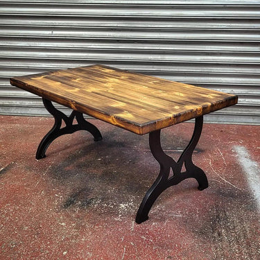 Handmade steampunk coffee table with rustic wood top and black iron industrial legs