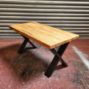 Industrial steampunk coffee table with solid wood top and black cross metal legs