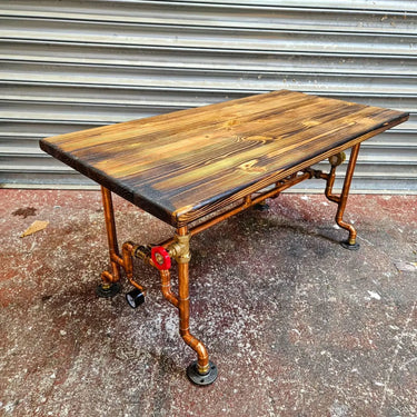 Industrial steampunk coffee table with copper pipe legs and rustic wooden top
