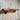Industrial pipe shelf with rustic wood plank mounted on weathered wood wall