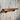 Handmade industrial wood and metal wall shelf on rustic wood panel backdrop