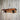 Handmade industrial wall shelf with wood plank and metal pipe brackets on rustic wall