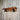 Wooden industrial pipe shelf mounted on rustic distressed wood wall