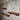 Set of three industrial pipe and wood wall shelves on rustic wooden wall