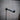 Wall-mounted industrial pipe clothes hanger rail on textured grey wall