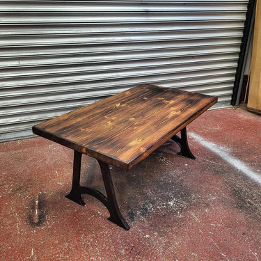 Handmade steampunk coffee table with dark wood top and industrial metal legs