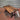 Industrial steampunk coffee table with dark wood top and black metal legs on concrete floor