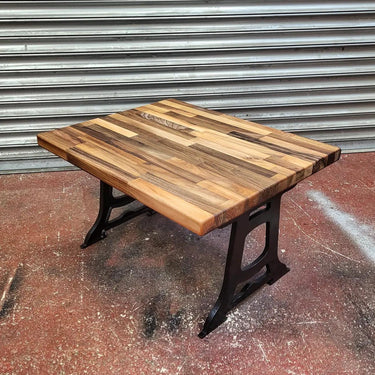 Industrial steampunk coffee table with solid wood top and black cast iron legs