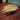 Millennium Falcon shaped wooden coffee table with industrial metal pipe legs on red floor