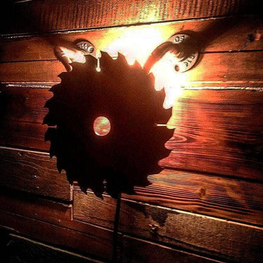 Rustic saw blade wall light with industrial style on wooden panel background