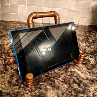 Steampunk industrial copper tablet stand on marble countertop kitchen setting