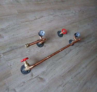 Handmade steampunk pipe toilet set with copper pipes, red valve handles, and pressure gauges