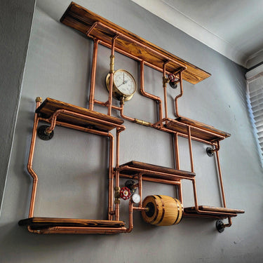 Steampunk industrial shelving unit with copper pipes, wood shelves, gauge, and barrel detail