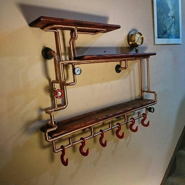 Steampunk industrial shelving unit with copper pipes, vintage gauges, wood shelves, and red hooks