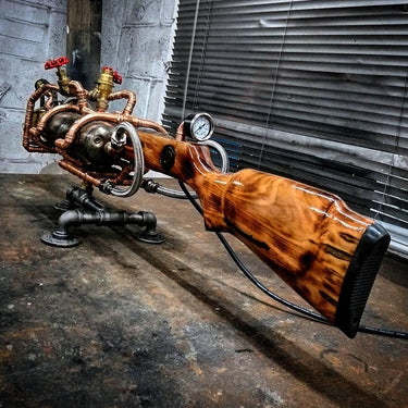 Steampunk industrial table lamp with wood finish, copper pipes, and pressure gauge on a workbench