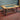 Steampunk coffee table with glass top, exposed copper pipes, and industrial metal legs