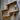 Steampunk shelving unit with copper pipes, wood shelves, and industrial gauges on wooden wall