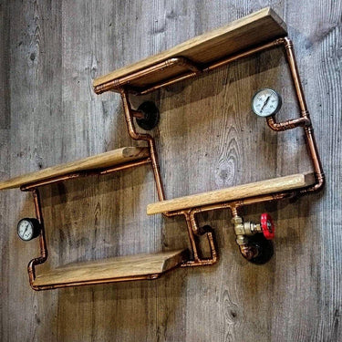 Steampunk shelving unit with copper pipes, wood shelves, and industrial gauges on wooden wall