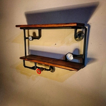 Industrial steampunk wall shelving unit with wood shelves, metal pipes, gauges, and valve
