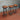 Set of three steampunk industrial bar stools with wooden seats and metal pipe bases