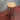 Steampunk industrial bar stool with wooden seat and metal pipe legs, vintage gauge accent