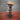 Steampunk bar stool with wooden seat and metal pipe base featuring industrial fittings.