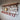 Steampunk coat rack with copper pipes, red hooks, pressure gauges, and a wood shelf