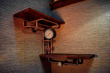 Steampunk industrial shelving unit with wood shelves, copper pipes, gauges, and valve on wall