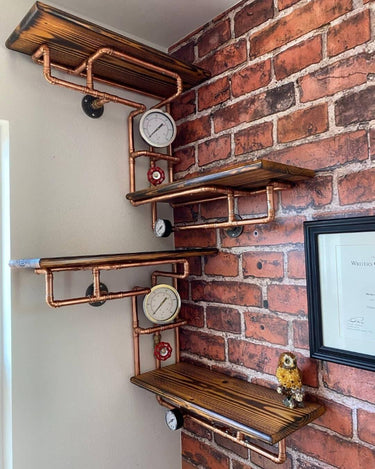 Steampunk shelving unit with wood shelves, copper pipes, and industrial gauges on a brick wall