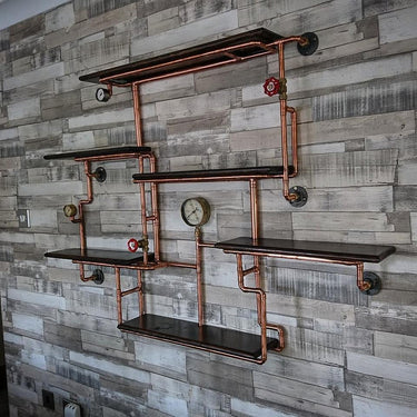 Steampunk shelving unit with copper pipes, pressure gauges, and dark wood on a rustic wall