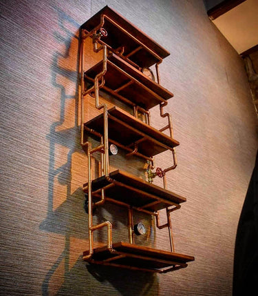 Steampunk wall-mounted shelving unit with wood shelves and industrial copper pipe frame