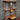 Steampunk shelving unit with copper pipes, wooden shelves, and industrial gauge decor