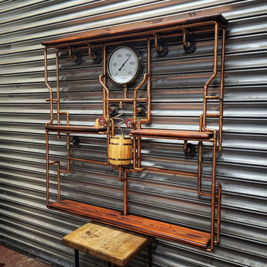 Steampunk shelving unit with copper pipes, wooden shelves, gauge, and industrial valves against metal wall