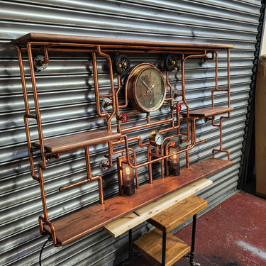 Steampunk shelving unit with copper pipes, vintage gauges, wood shelves, and industrial lights