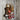 Handmade steampunk wall hook with red pipe hooks, gauge, and wood barrel on rustic wall