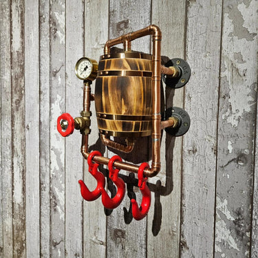 Handmade steampunk industrial wall hook with copper pipes, wood barrel, and red hooks